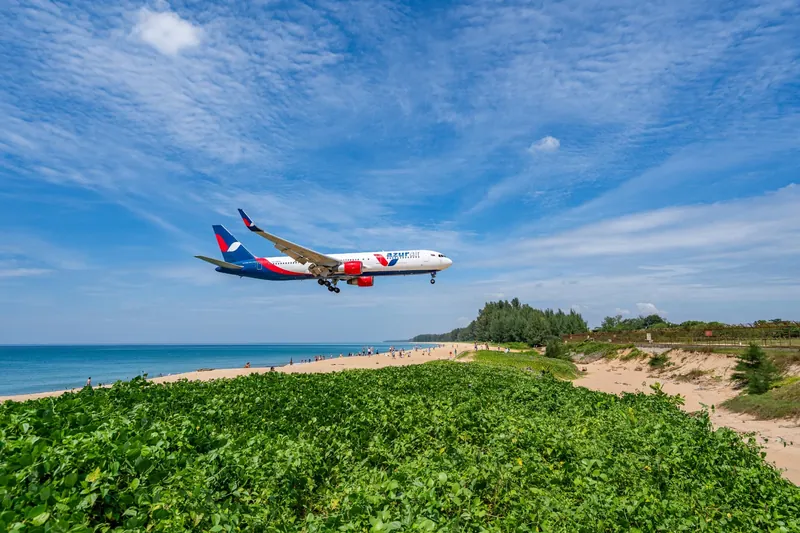 A wide-body jet on final approach over Mai Khao beach beside Phuket airport