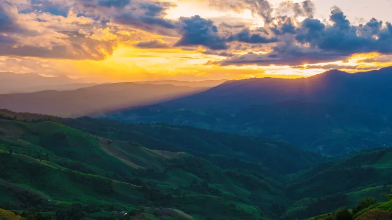 Sunset over the green mountain ridges of Thailand's far north