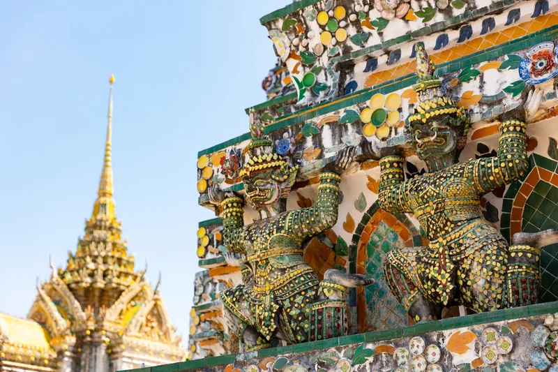 Mosaic guardian figures on the spire of Wat Arun in Bangkok