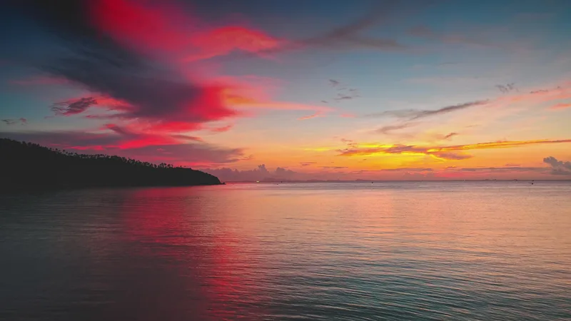 A vivid red and gold sunset over the sea off Koh Phangan