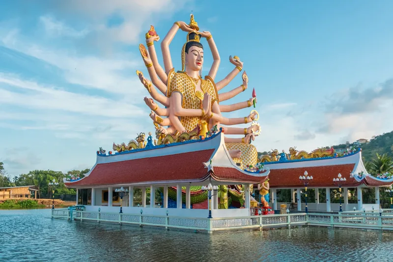 Wat Plai Laem temple on Koh Samui, its giant multi-armed Guanyin statue rising above the lake