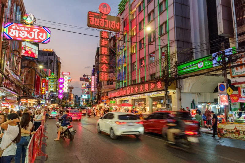Neon signs and evening crowds along Yaowarat Road in Bangkok's Chinatown